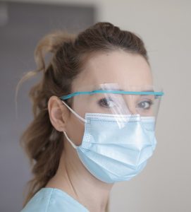 Woman wearing a face masks and eye covering